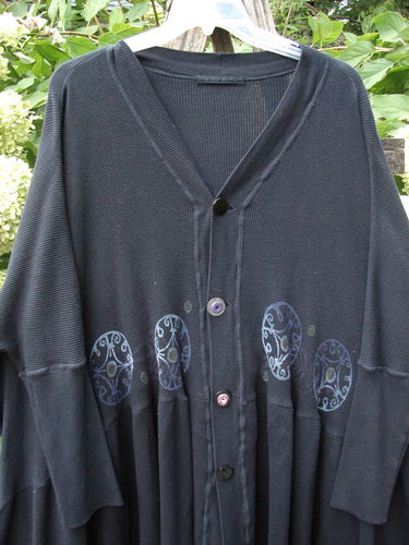 1997 Thermal Bungalow Jacket with a V-neck and four mismatched buttons. Features wide sleeves, pleated skirt-like lower half, and Celtic medallion appliqués, reflecting Bluefishfinder.com's vintage, creative style.
