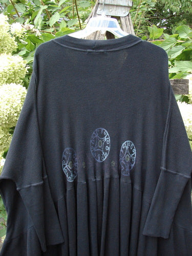 1997 Thermal Bungalow Jacket Celtic Medallion Cast Iron OSFA displayed outdoors, featuring three decorative medallions across the back, with a flowing design and ribbed cuffs, embodying vintage Blue Fish style.