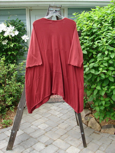 Image alt text: Barclay Gather Two Pocket Dress, a red shirt on a rack, with a sweet front vertical gather, A-line shape, and wide three-quarter length sleeves.