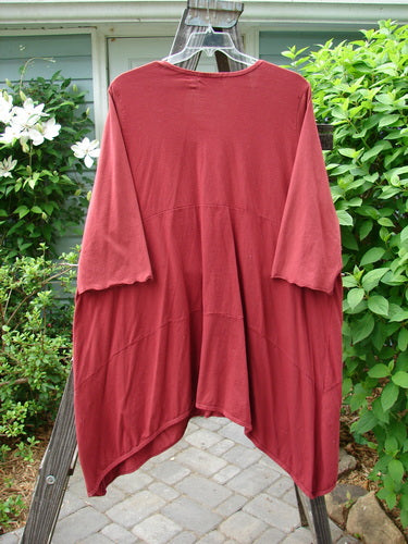A red Barclay Gather Two Pocket Dress made from medium weight organic cotton, featuring a sweet front vertical gather, A-line shape, and wide three-quarter length sleeves. Two exterior front drop pockets. Size 2.