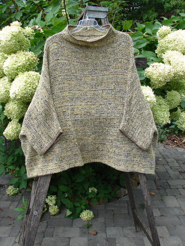 Barclay Alpaca Big Square Mock Collar Sweater Marled Sun OSFA draped on a wooden ladder, showcasing its loose knit, dolman shoulders, and three-quarter sleeves in a natural outdoor setting.