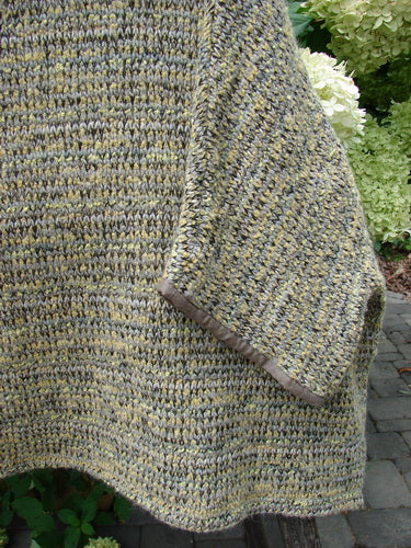 Barclay Alpaca Big Square Mock Collar Sweater Marled Sun OSFA displayed with three-quarter sleeves, mock turtleneck, and dolman shoulders, draped outdoors, highlighting its unique texture and craftsmanship against a natural backdrop.