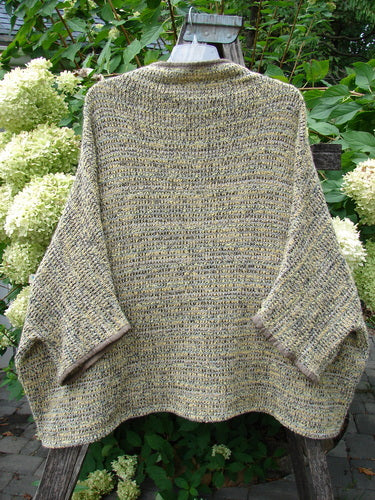 Barclay Alpaca Big Square Mock Collar Sweater Marled Sun OSFA draped on a ladder, showcasing its loose fit, three-quarter sleeves, and dolman shoulders, made with a breathable alpaca knit blend.
