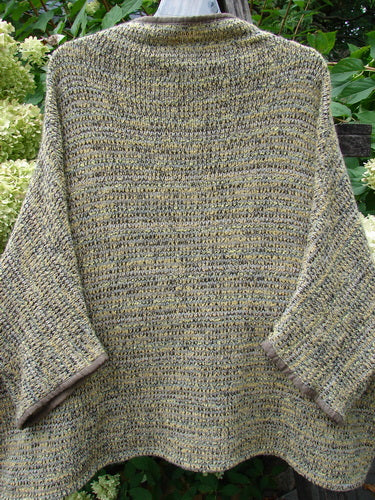 Barclay Alpaca Big Square Mock Collar Sweater Marled Sun OSFA features a loose, boxy shape with three-quarter-length sleeves, mock turtleneck, and dolman shoulders, draped on a hanger outdoors.