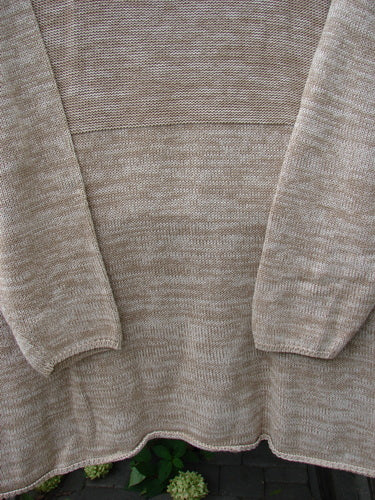 Barclay Jennifer's Rollneck Sweater Marled Aspen OSFA features a tunic-length, marled-yarn knit with rolled hems and textured knits, showcasing its generous drape and empire waist seam against a brick backdrop.