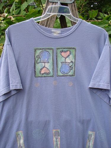 1999 Short Sleeved Tee Reverse Heart Vase Iris Size 2 displayed outdoors, featuring unique reverse heart and pitcher design with utensil motifs on hem, showcasing BlueFishFinder's vintage, creative apparel.
