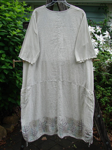 Barclay Linen Farmer Jen Dress Moon Path Flaxen Size 2 features a sectional bodice, wrap-around pockets, paneled hem, drawcord sides, and cotton sleeves with lettuce edges, embodying vintage Blue Fish creativity.