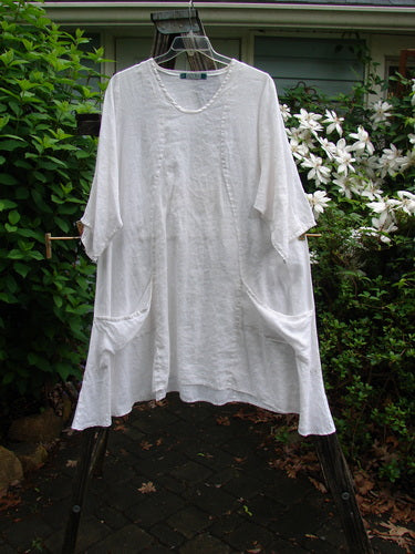 Barclay Linen Side Pocket Tab Tunic Dress Unpainted White Size 2, featuring a slightly scooped neckline, S-shaped seams, longer short sleeves, and two drop flop pockets, crafted for versatile mix and match styling.