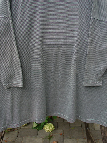 1999 Cotton Lycra Square Mock Pullover Unpainted Black Stripe Size 2, featuring a boxy shape and dolman drop shoulders, displayed draped over a bench, highlighting its fine horizontal pin-stripes.