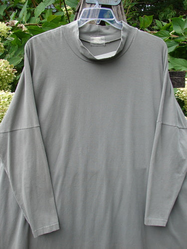 1999 Cotton Lycra Square Mock Pullover Unpainted Grey Stone Size 2, featuring a light-gray oversized design with dolman drop shoulders and a stand-up mock turtleneck, displayed outdoors on a hanger.