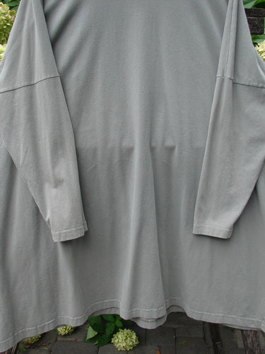 1999 Cotton Lycra Square Mock Pullover Unpainted Grey Stone Size 2 draped outdoors, showcasing its A-line cut, long sleeves, and stand-up mock turtleneck, embodying BlueFishFinder's vintage, expressive style.