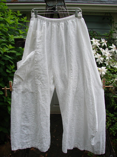 Barclay Linen Upper Dual Pocket Dimension Pant Unpainted White Size 2, featuring a full elastic waistline, vertical seams, billowy flair, upper tiny pocket, and a larger side wrap pocket, suited for creative expression.