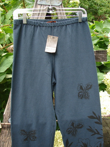 Barclay NWT Cotton Lycra Straight Pant Botanicals Lux Silhouette Size 1, features a soft jersey fabric with floral/butterfly prints, elastic waistband, and cropped design, showcased outdoors with greenery.