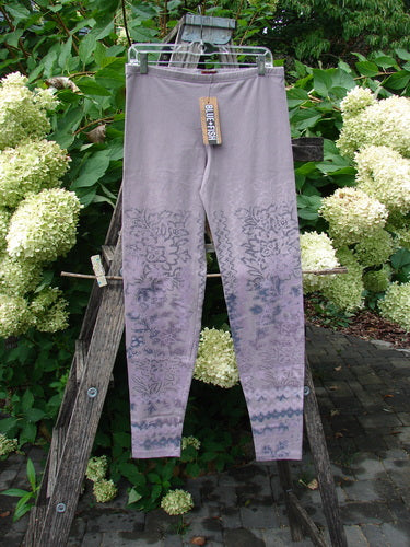 Barclay NWT Cotton Lycra Basic Legging Tiny Botanicals Sea Fog Size 1, hanging on a wooden ladder, showcases a full elastic waistband with darker floral prints on lower legs, retail tag attached.