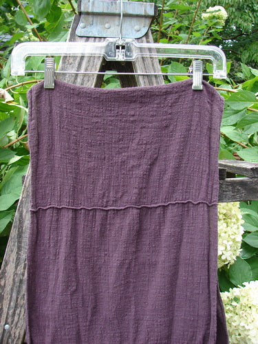 Barclay Gauze Sectional Scarf Wrap Unpainted Deep Burgundy OSFA displayed outdoors on a clear hanger, showcasing its textured fabric and sectional seams, representing the creative, vintage essence of BlueFishFinder.com.