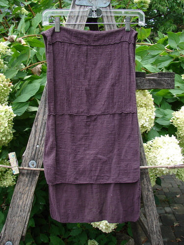 Barclay Gauze Sectional Scarf Wrap Unpainted in Deep Burgundy, draped on a wooden ladder, showcasing its lightweight cotton gauze and unique sectional seams. Perfect for expressing individuality with vintage flair.