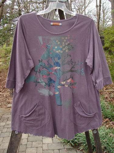 Barclay Banded Sleeve Twinkle Pocket Top Bonsai Tree Plum Size 1, featuring a tree design, rounded neckline, A-line shape, double exterior pockets, three-quarter sleeves, and rounded hemline.