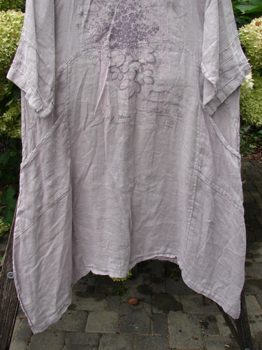 Barclay NWT Linen Wave Pocket Dress Floral Bunch Vintage Quartz Size 1 draped on a chair, features a loose fit, uneven hem, floral chest print, and inset side pockets, reflecting Bluefishfinder.com's vintage style.