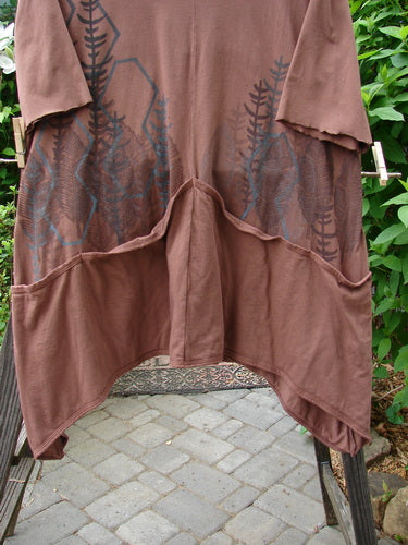 Brown shirt with design on clothesline, forest-themed tunic dress with drop pockets, made from organic cotton. Size 2.