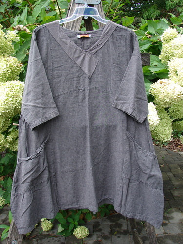 Barclay Linen Cross Over Urchin Pocket Dress Stripe Fig Size 1, featuring a loose fit, V-neck, elbow-length sleeves, large hip pockets, and a mid-length cut, displayed on a clear hanger outdoors.