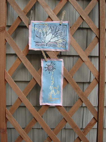 A pair of art pieces on a wooden lattice from The PMU 1997 Summer Sun and Forest Patch Set Total 2.