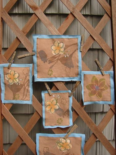 Image alt text: "The PMU 2000 Spring Floral Patch Set - a group of fabric squares with flowers on them, mounted on organic cotton"