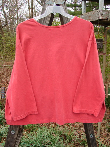 Barclay Long Sleeved Crop Oversized Tee Crane Sherbet OSFA displayed on a wooden rack, showcasing its wide shape and rounded, rolled neckline. Made from mid-weight organic cotton, perfect condition.