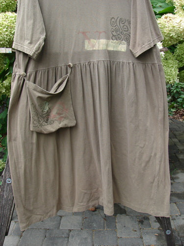 1994 Flower Garden Dress Wind Medallion Bark Size 2 draped on a trellis; features a slightly scooped neckline, drop waist, gathered skirt, and a small pocket with a faint NY print.