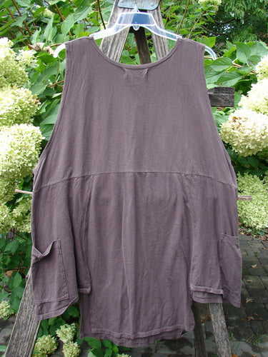 Barclay NWT Flower Pot Top Botanicals Brown Sparrow OSFA, featuring a loose fit, high round neckline, oversized patch pockets, and a dropped waistline seam, hanging outdoors against a lush green backdrop.