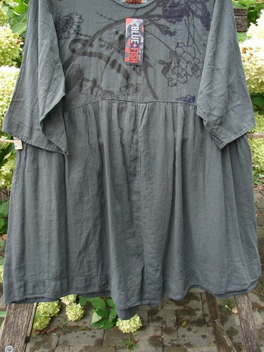 Barclay NWT Textured Terrarium Dress Contour Floral Ironworks Size 1, featuring a muted gray, smock-style with subtle floral print, three-quarter sleeves, and A-line shape, displayed outdoors against hydrangeas.