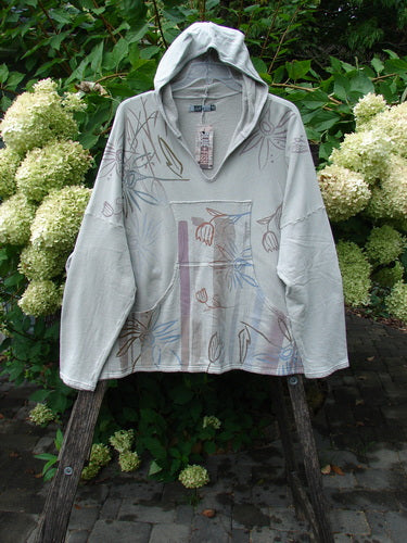 Barclay NWT Fleece Modal Hip To Be Square Hoodie Contour Floral Cloud OSFA draped on a wooden stand, showcasing its cozy, lightweight design with subtle floral print and functional pockets.