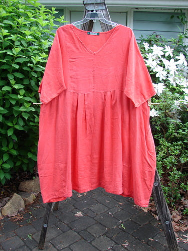 Barclay Linen Pleated Pocket Swing Dress Unpainted Geranium Size 2 features a slightly dipped neckline, wide pleats, empire waist, curved seams, low inseam pockets, drawcord rear, and generous short sleeves.