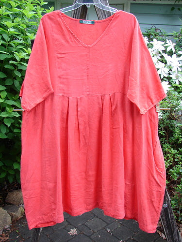 Barclay Linen Pleated Pocket Swing Dress Unpainted Geranium Size 2, featuring a slightly dipped neckline, wide pleats, empire waist, short sleeves, and dual pockets. Ideal for vintage-inspired summer style.