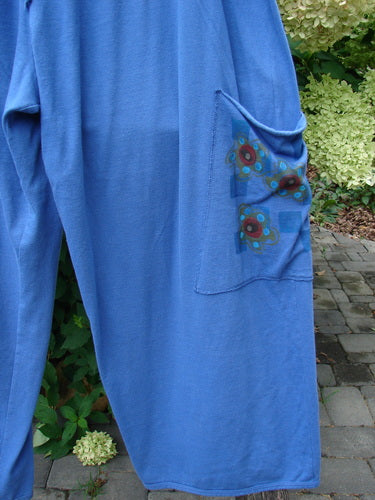 Barclay Drawstring Double Pocket Pant Shop Purse Skylark Size 2, featuring double exterior pockets with floral-geometric print, displayed hanging outdoors against green foliage and paving stones, embodying vintage Blue Fish Clothing style.