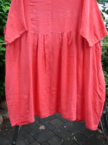 Barclay Linen Pleated Pocket Swing Dress Unpainted Geranium Size 2, featuring a dipped neckline, full pleats, empire waist, curvy seams, inseam pockets, drawcord rear, and wide sleeves.