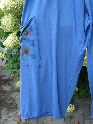 Barclay Drawstring Double Pocket Pant Shop Purse Skylark Size 2, showcasing a relaxed fit with a drawstring waist, wide lowers, and painted pockets, hanging in front of a hydrangea bush.