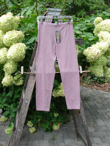 Barclay NWT Cotton Lycra Crop Legging Unpainted Tulsi Rose Size 0 displayed on a hanger against a wooden ladder, showcasing its soft texture and slim fit design with a tag attached.