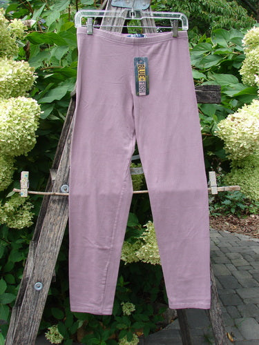 Barclay NWT Cotton Lycra Crop Legging Unpainted Tulsi Rose Size 0 hanging from a ladder, showcasing a full elastic waistband and tapering lowers, ideal for versatile summer styling.
