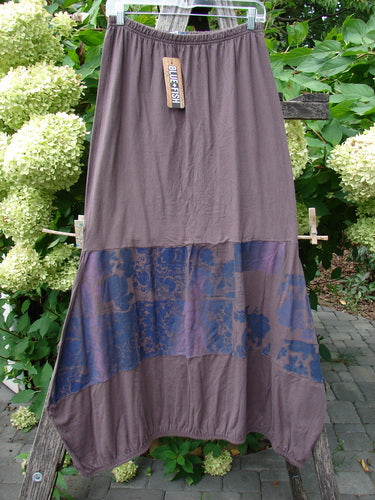 Barclay NWT Sprig Skirt Grid Garden Brown Sparrow Size 0, featuring an elastic waistband, mottled blue-brown paneled lower section, and a reverse bell shape, displayed outdoors on a hanger.
