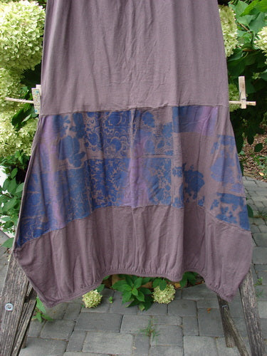 Barclay NWT Sprig Skirt Grid Garden Brown Sparrow Size 0 displayed outdoors, showcasing its muted brown fabric with a blue patterned band, elastic waist, and paneled hem.