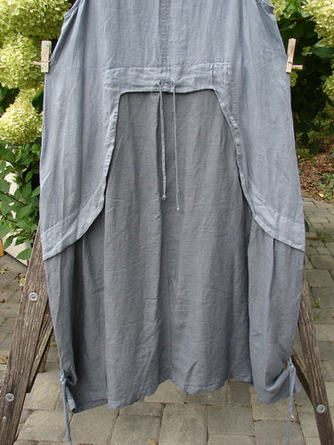 Barclay NWT Linen Explorer Jumper Trailing Botanicals Blue River Mist Size 0 hangs on a clothesline, showcasing its sleeveless smock style, scoop neckline, and billowy lower sweep with drawcord waist.