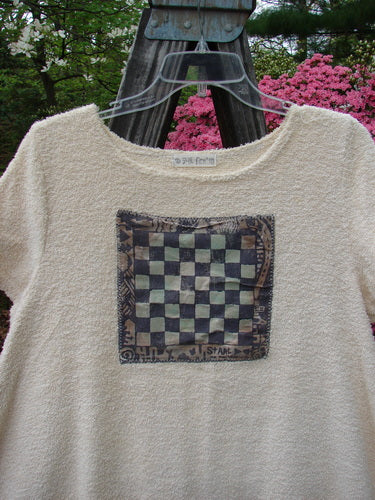 1996 Patched French Terry Shoreline Dress Checker White Pine Size 0 featuring a checkerboard design, two painted patches, drawcord back with metal grommets, and a sweeping A-line shape displayed outdoors.