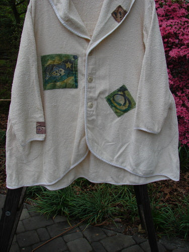 1996 Patched French Terry Cape Cod Coat in White Pine OSFA, featuring oversized front pockets, a single button closure, V-neck collar, farm-themed patches, and a sweeping A-line shape.