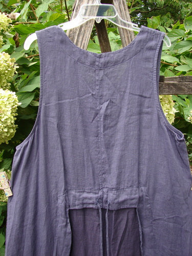 Barclay NWT Linen Explorer Jumper Botanical Blossom Purple River Mist Size 0, featuring a loose-fitting, sleeveless design with tie-strings at the back waist, hung on a clear hanger outdoors.
