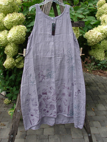 Barclay NWT Linen Sundress Garden Folly Amethyst Size 0, featuring a loose-fitting shift design with nature-inspired motifs near the hem, patch pockets, and a varying hemline, hanging outdoors against white hydrangeas.
