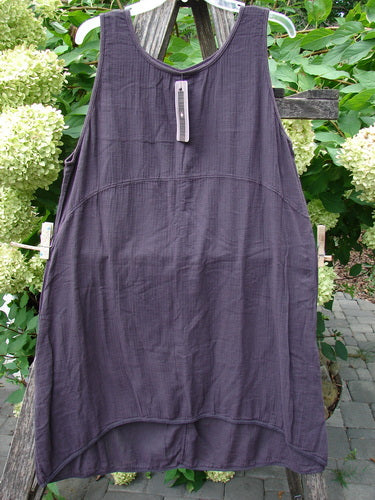 Barclay NWT Textured Salted Shift features a dark gray loose-cut, sleeveless design with a rounded neckline and varying hemline, displayed on a rustic bench, highlighting its casual elegance.