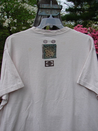 1996 Short Sleeved Tee Split Fish Birch Bark Size 2, featuring a unique design on a white medium-weight organic cotton fabric, ribbed neckline, drop shoulders, and a blue fish patch.