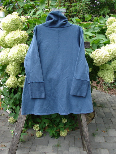 Barclay NWT Fleece Cowl Neck Sweatshirt Metallic Daisy Vintage Indigo Size 0 draped over a wooden ladder, showcasing its A-line shape, flop Celtic moss cowl collar, and cozy wide sleeves.