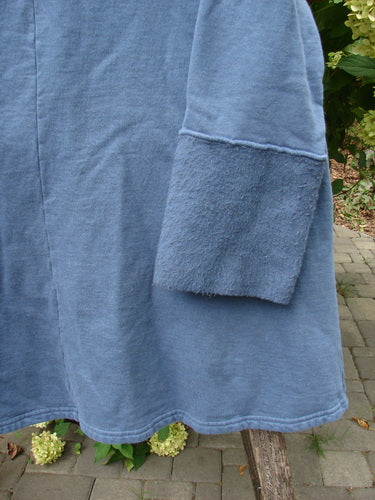 Barclay NWT Fleece Cowl Neck Sweatshirt Metallic Daisy Vintage Indigo Size 0, featuring smooth jersey knit and cozy fleece cuff, draped over a wooden bench outdoors.