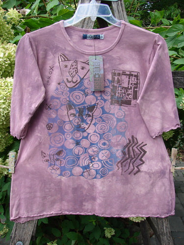 Barclay NWT Cotton Lycra Horizon Tee BF Logo Cats Mottled Pinkberry Size 0 features abstract cat faces and geometric shapes on a hand-dyed short-sleeve tee, displayed on a wooden ladder.
